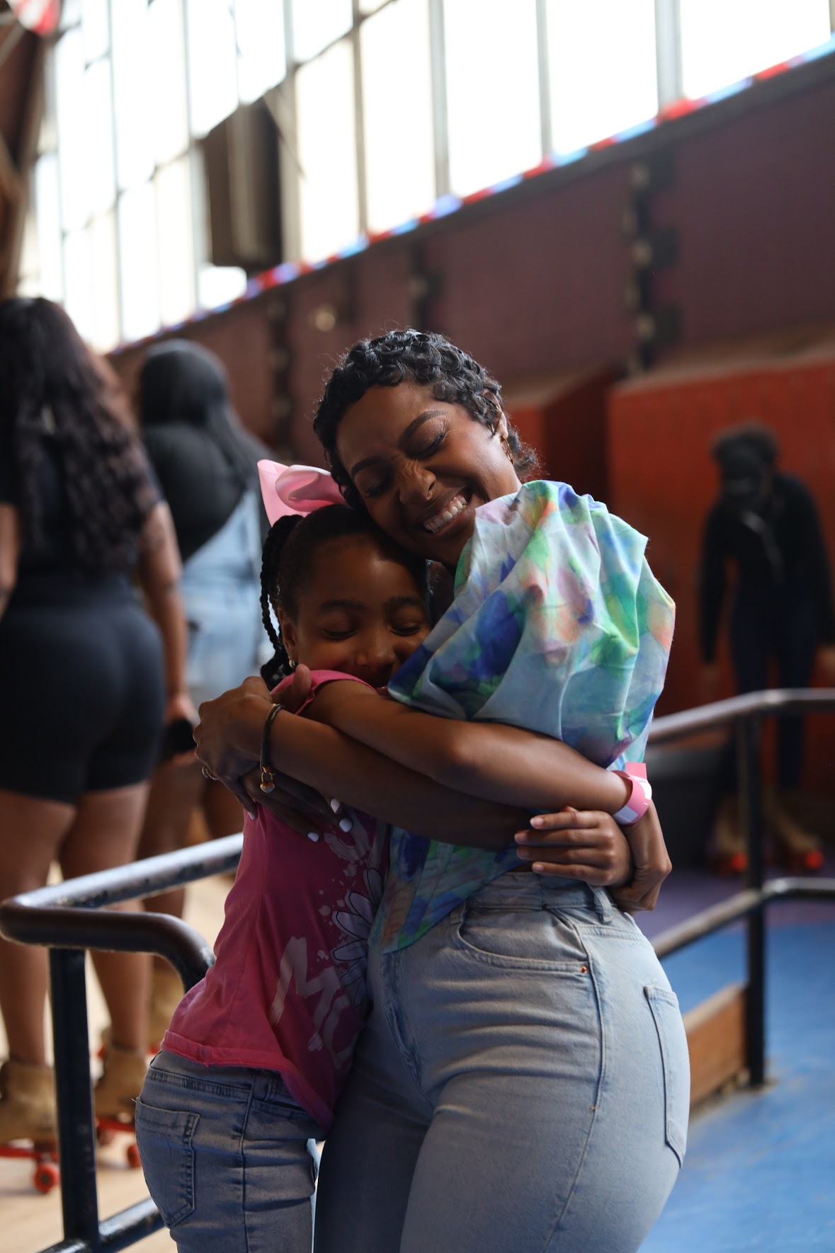 Lynda hugging a young mentee